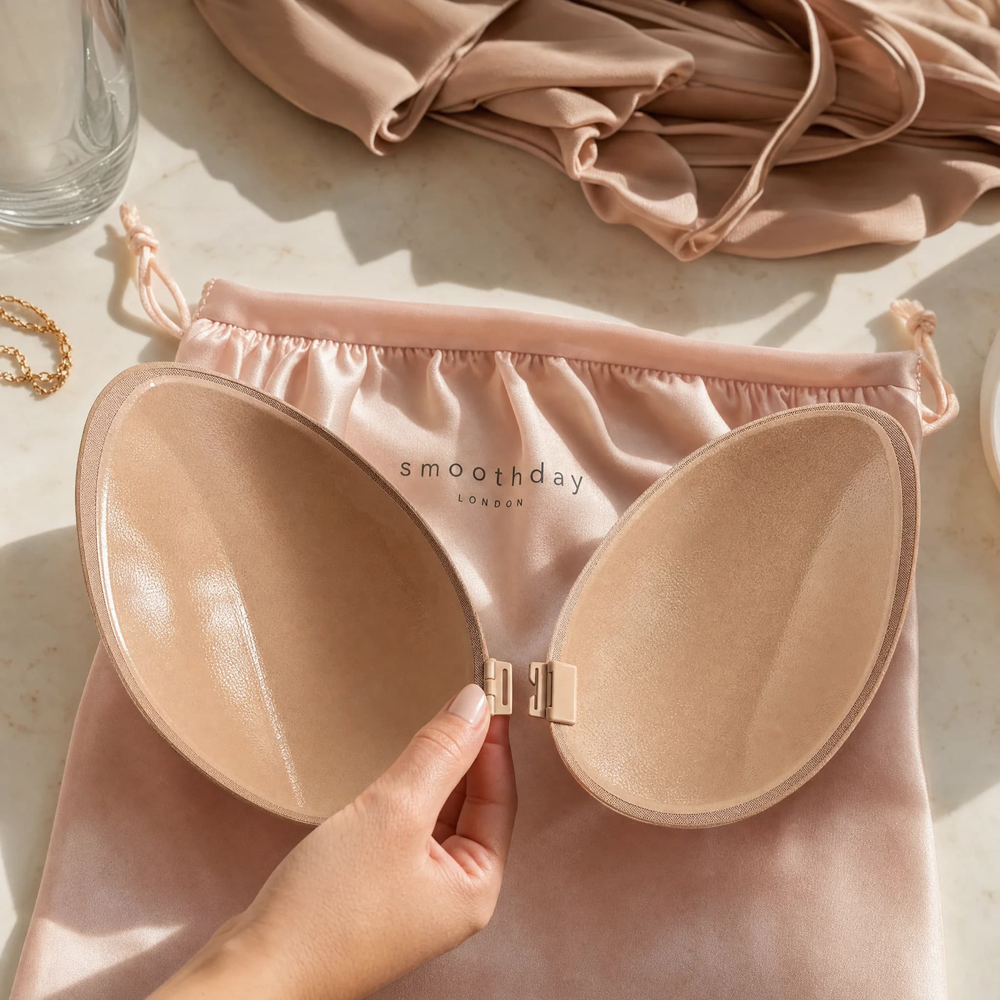 Separated adhesive bra cups showing the front-closure shape